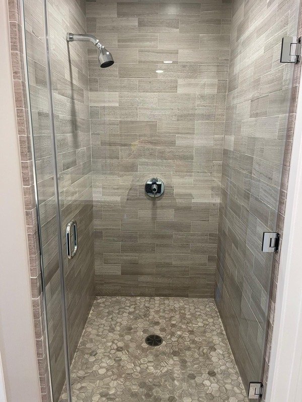 Tile shower cleaned and sanitized during a deep cleaning in a Maryland home