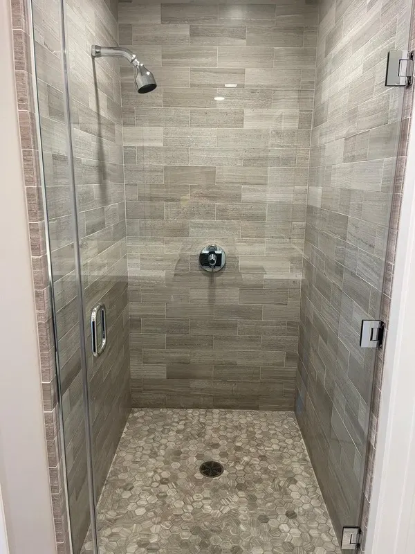 Tile shower cleaned and sanitized during a deep cleaning in a Maryland home