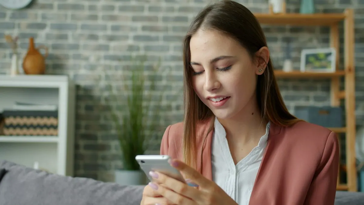 Person at home sending a cleaning request from a smartphone